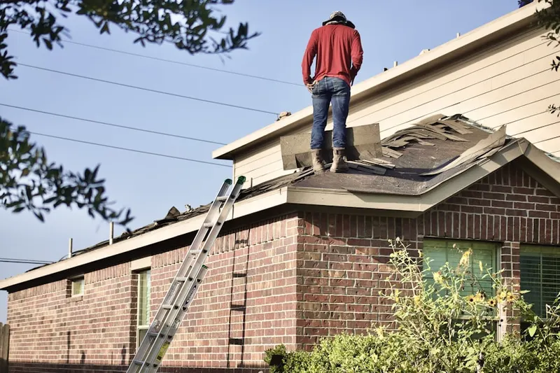 Professional roofer working on a residential roof in Rosegarden